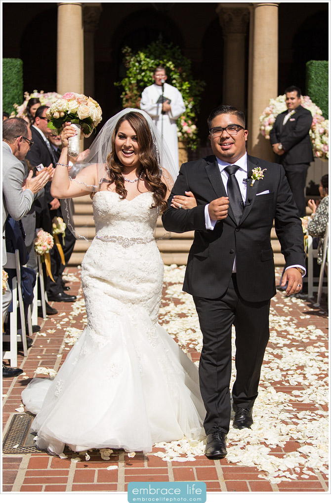 Bride and Groom celebrating as they walk down the aisle as husband and wife