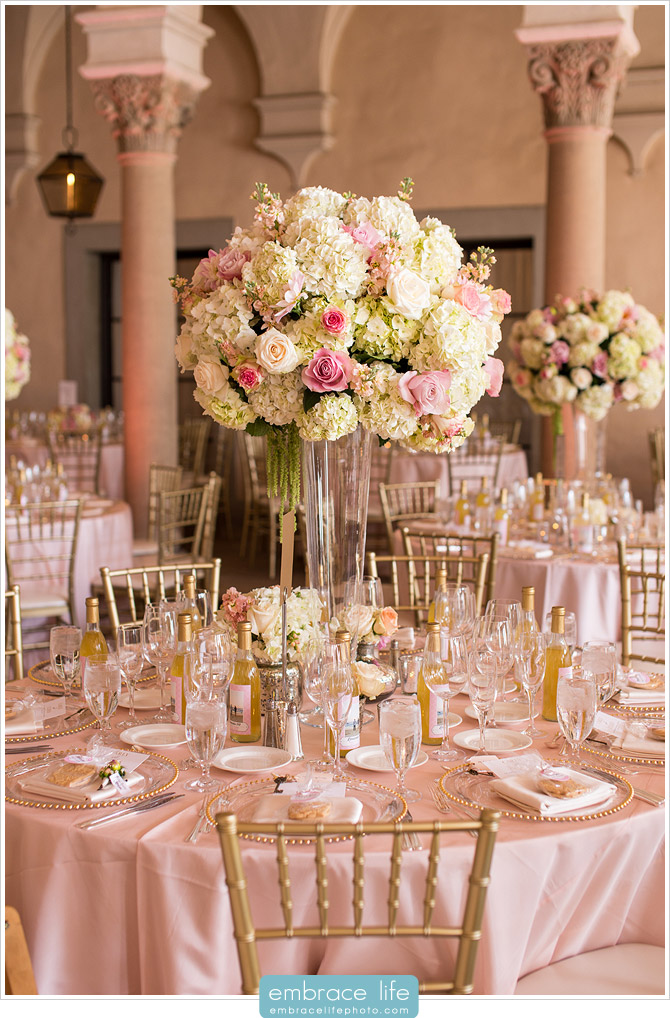 Elevated floral centerpieces with hydrangeas and pink roses at pink wedding reception
