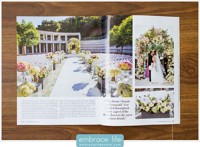 Bride and Groom share their first kiss surrounded by stunning floral arrangements and garden wedding chuppah at Skirball Center in Los Angeles